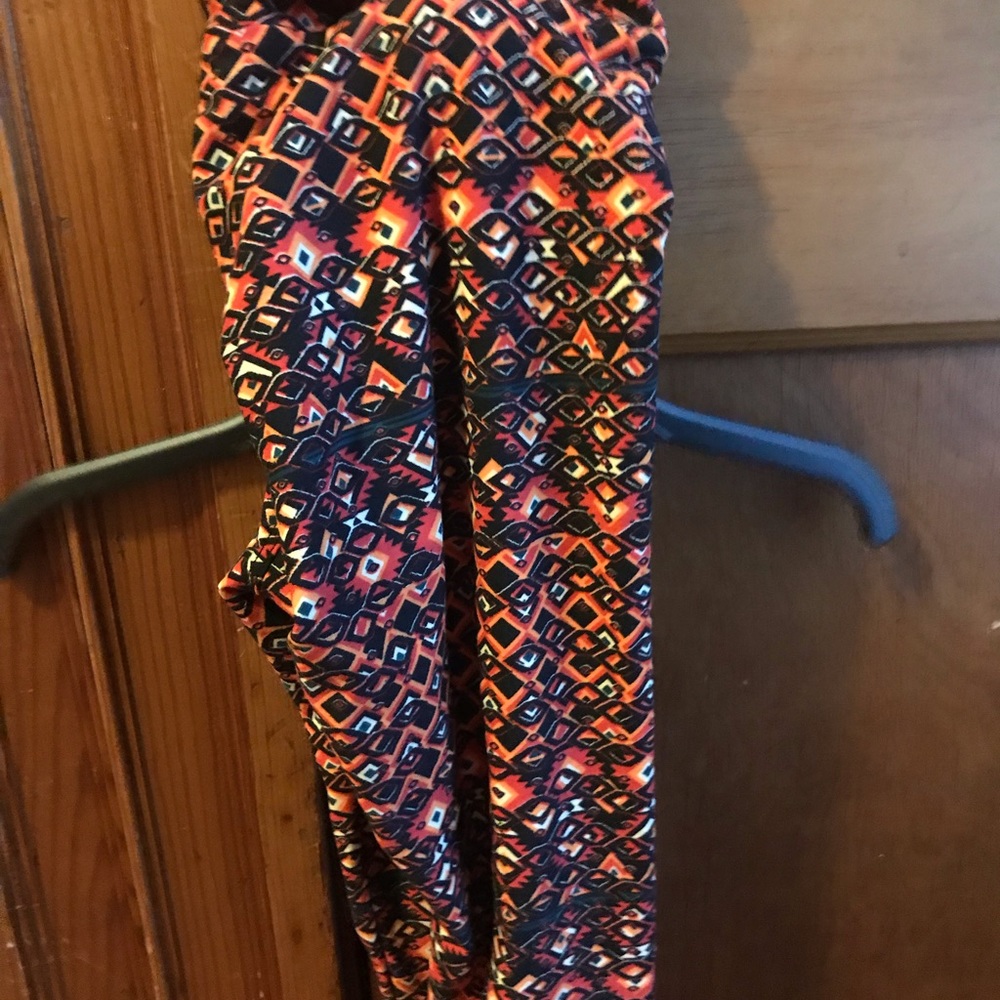 Never worn lularoe leggings. Yellows oranges black